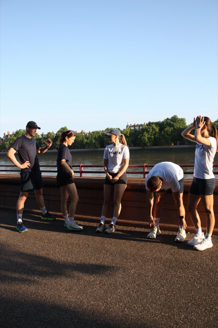 Runners stretching on the Thames path before a run